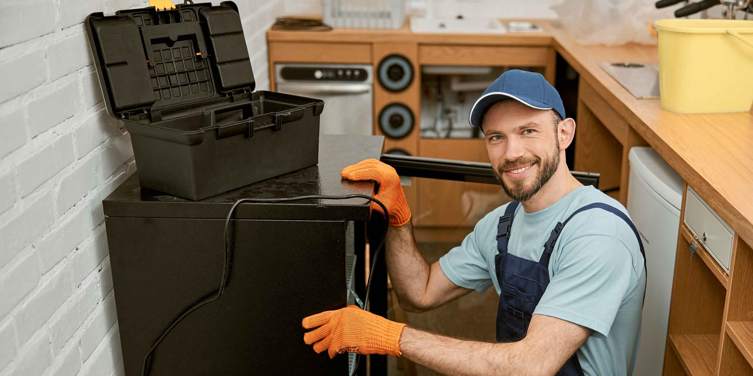 worker sitting next to a tool chest